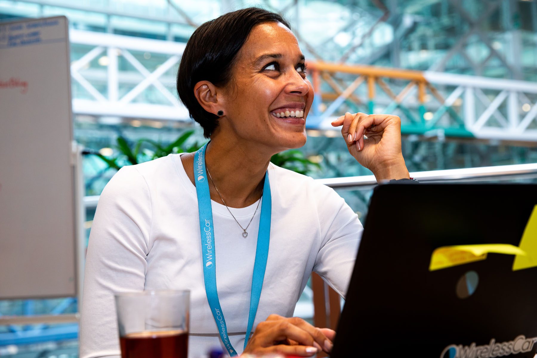 Close-up of person smiling in front of a computer