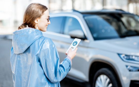 person unlocking car with a smartphone