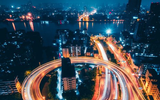 Aerial view of city with roads and lights at night