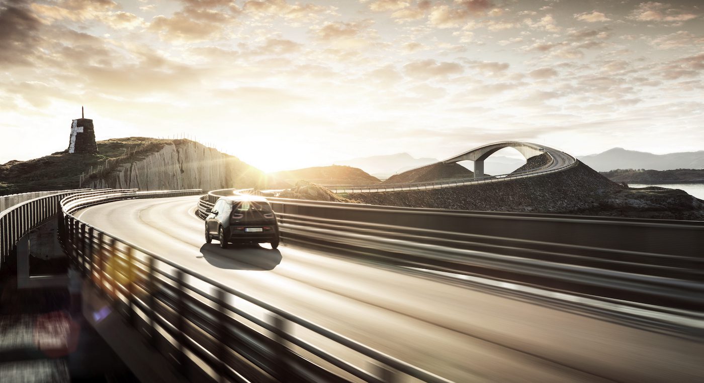 Car moving on a road at sunset