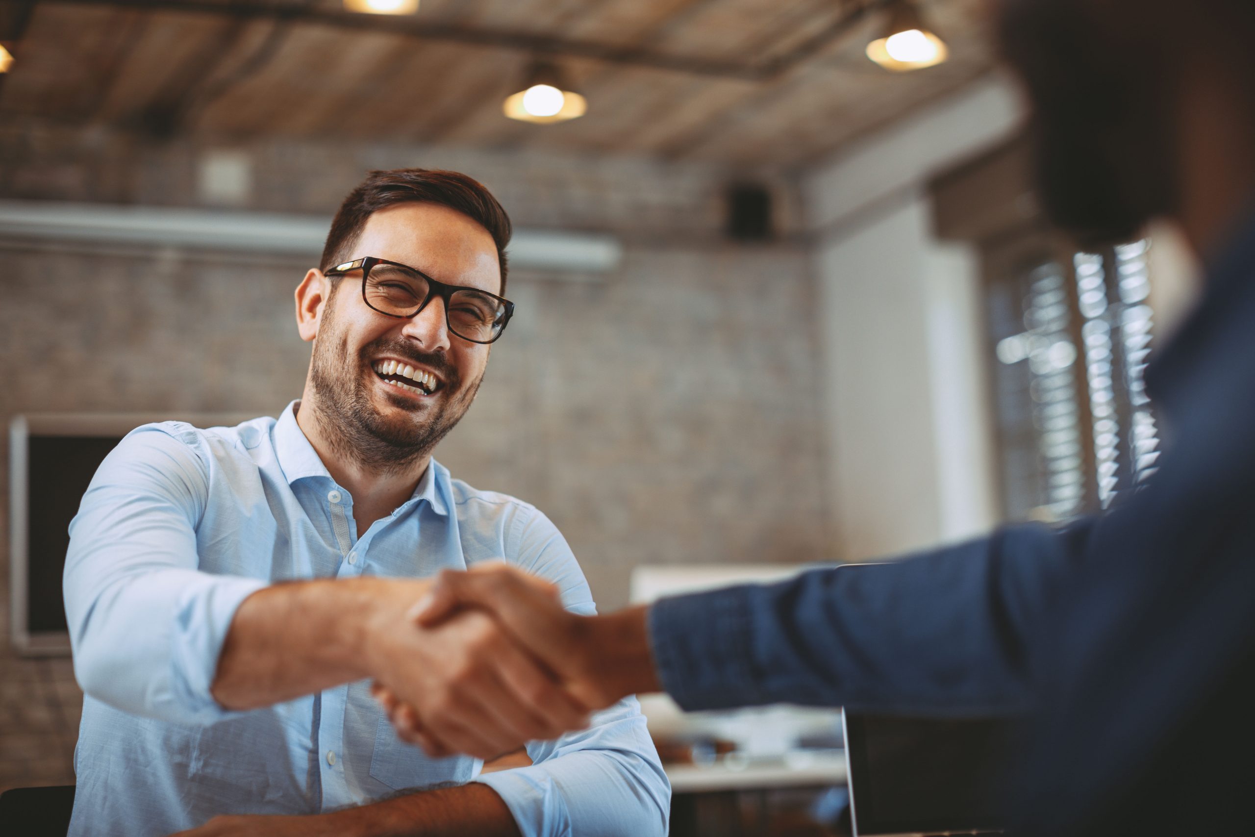 A happy man shaking hands