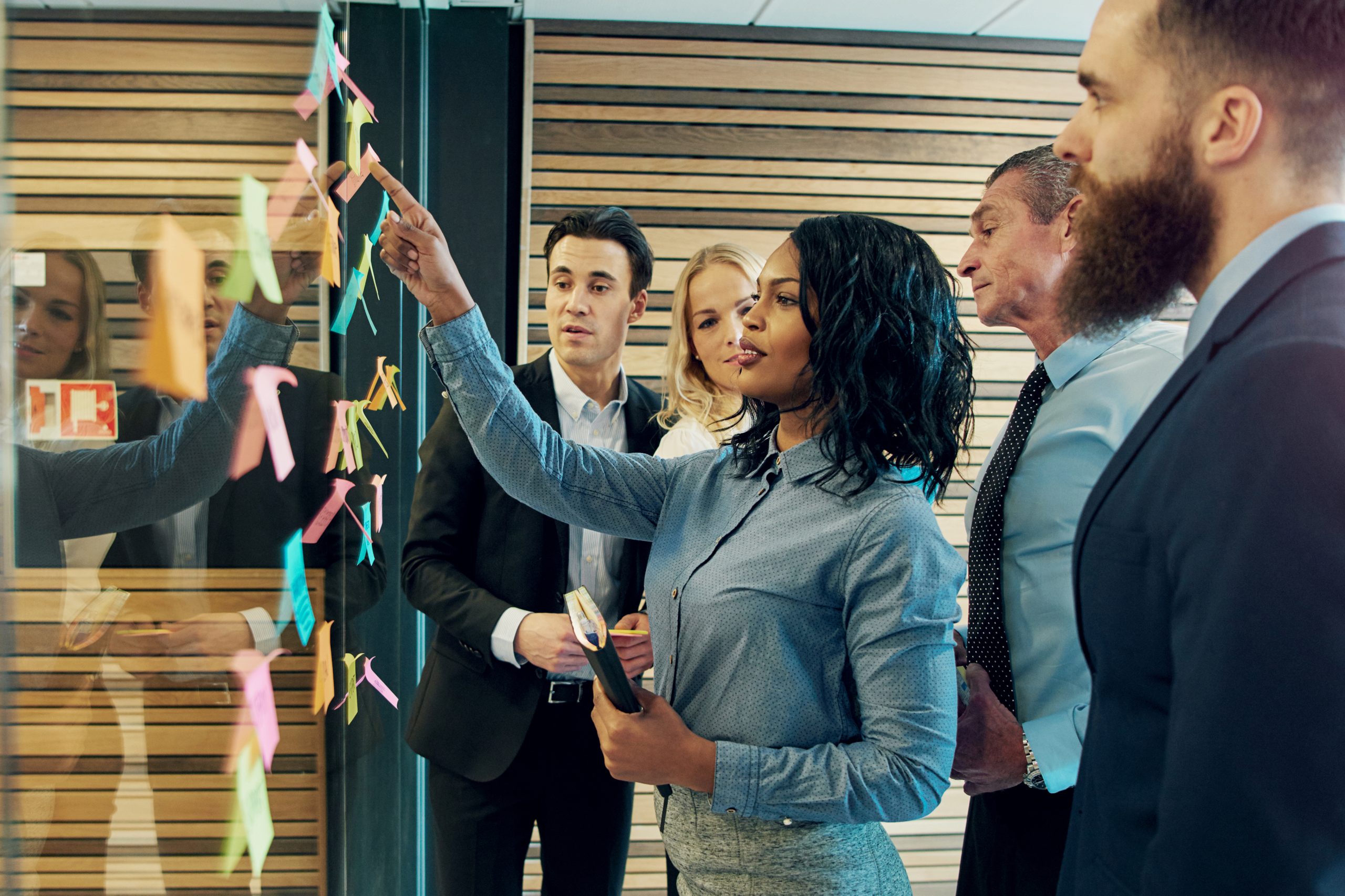 Journey intelligence why WirelessCar A group of people working with post-it notes in an office