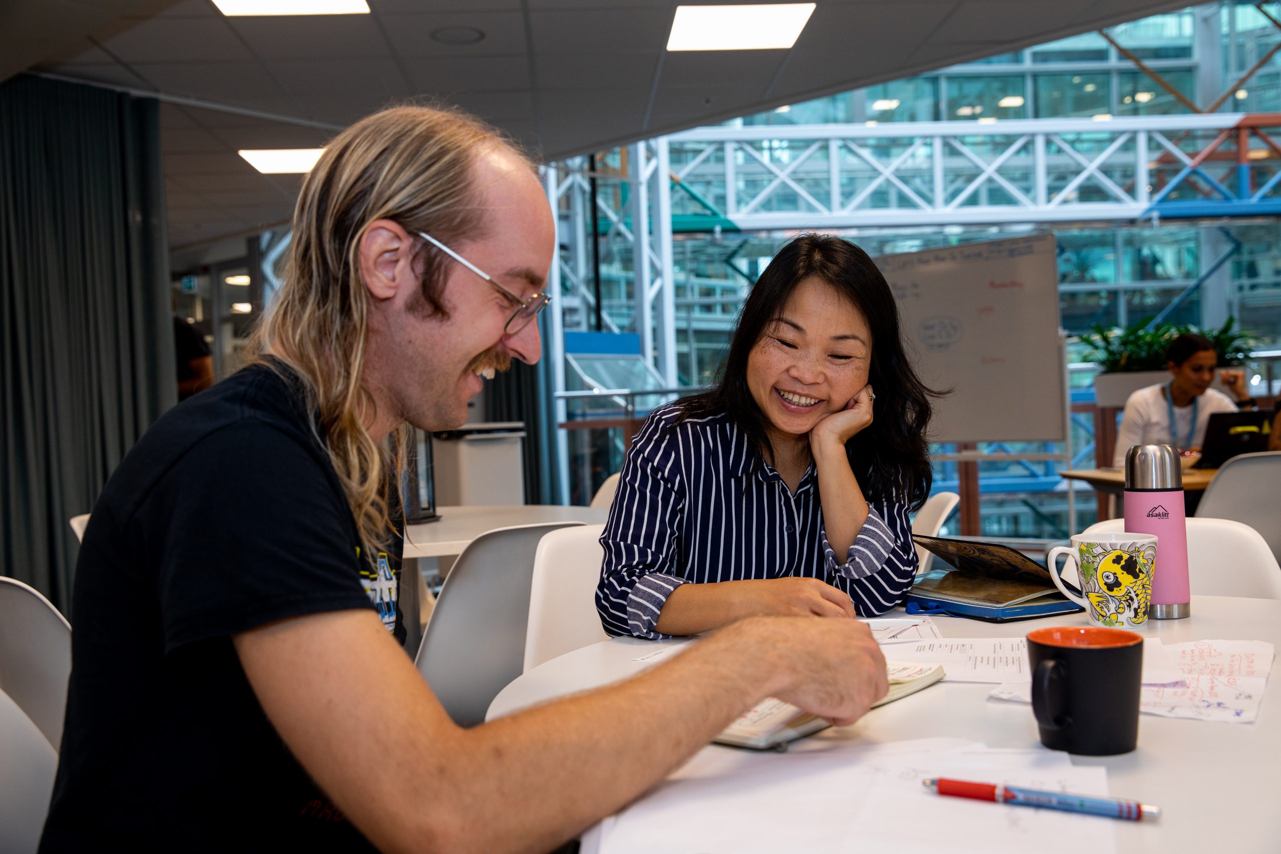 Electric vehicles Why WirelessCar Two people sitting at a table smiling