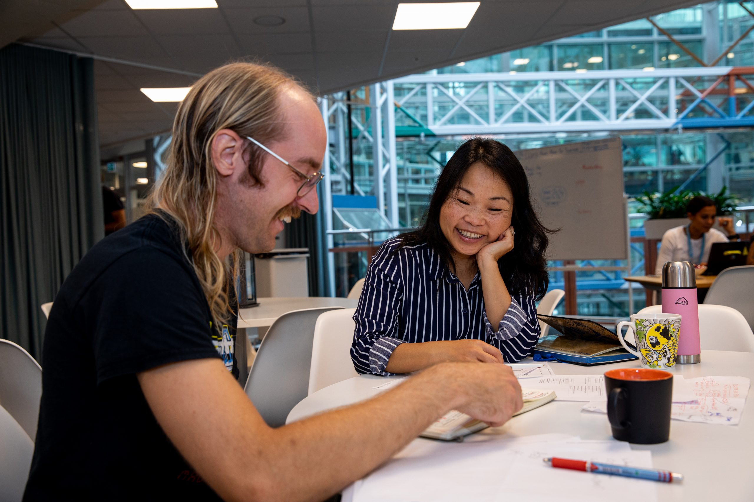 Two people sitting at a table smiling