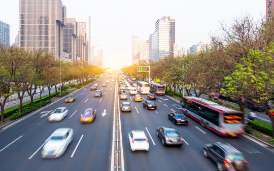 cars driving on a highway in a big city