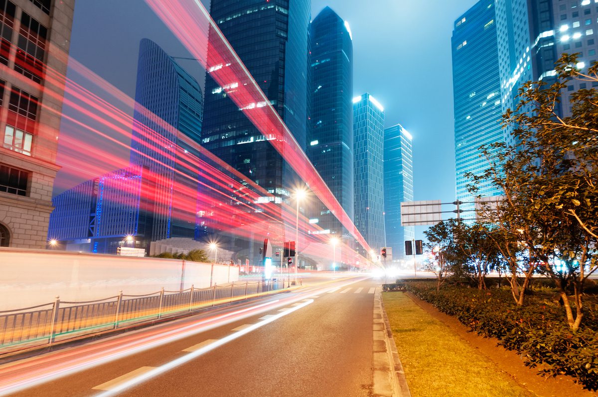 cars and city lights with skyscrapers