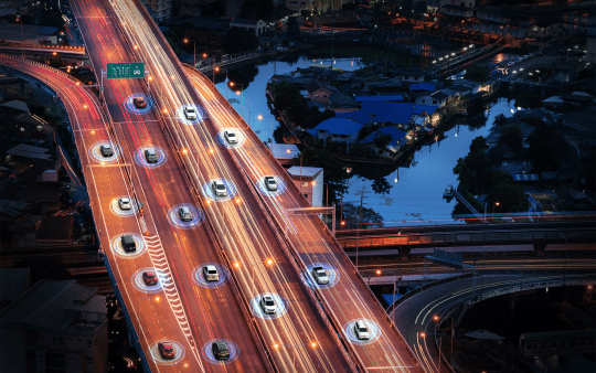vehicles on a highway in the evening with blue circles beneath each vehicle