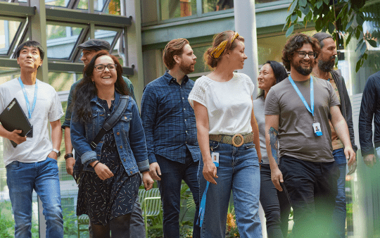 A group of people walking and talking to each other