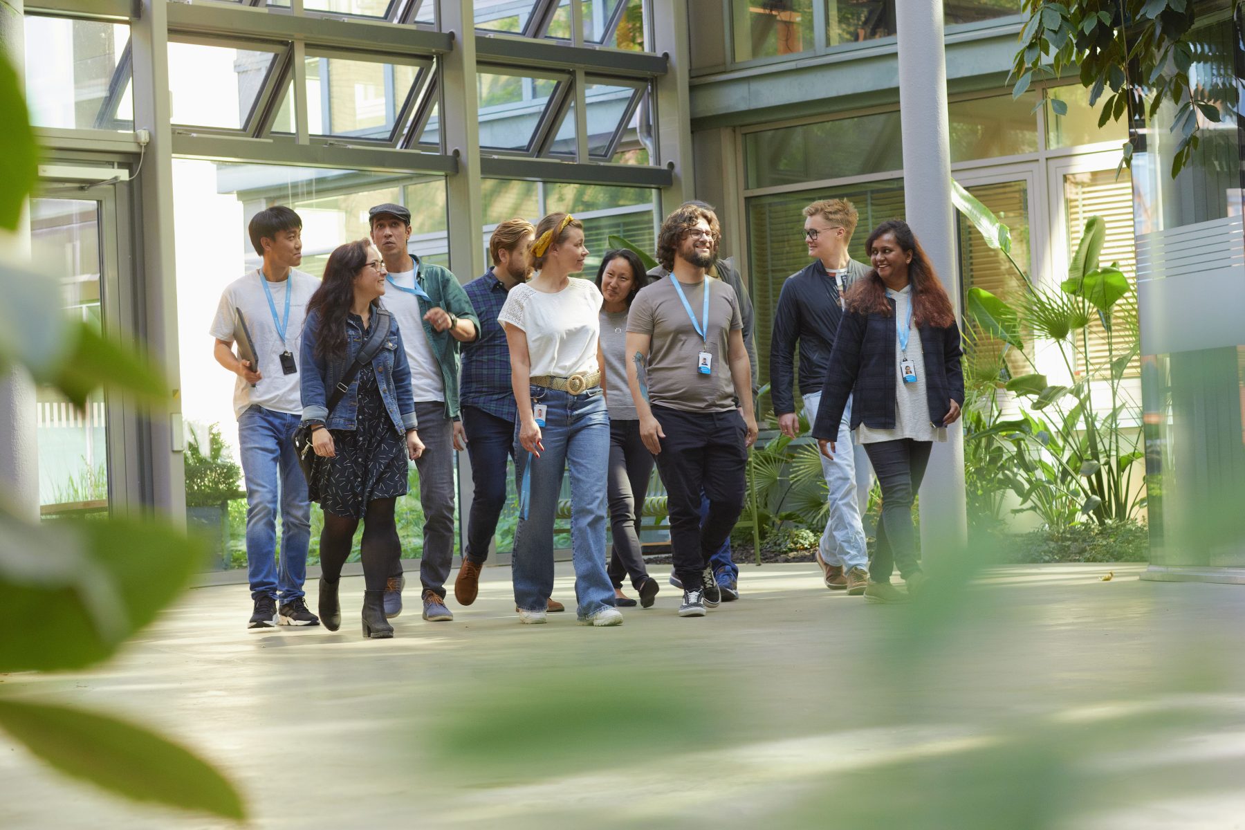 A group of people walking and talking to each other