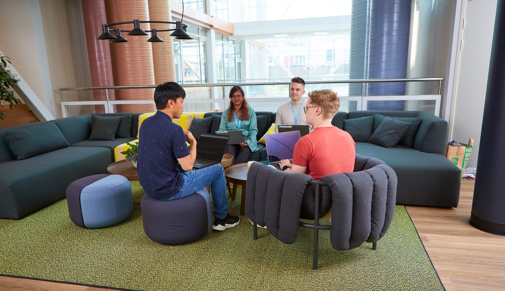 a group of people talking to each other in an office