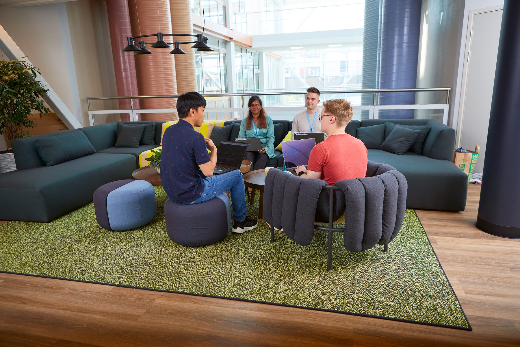 a group of people talking to each other in an office