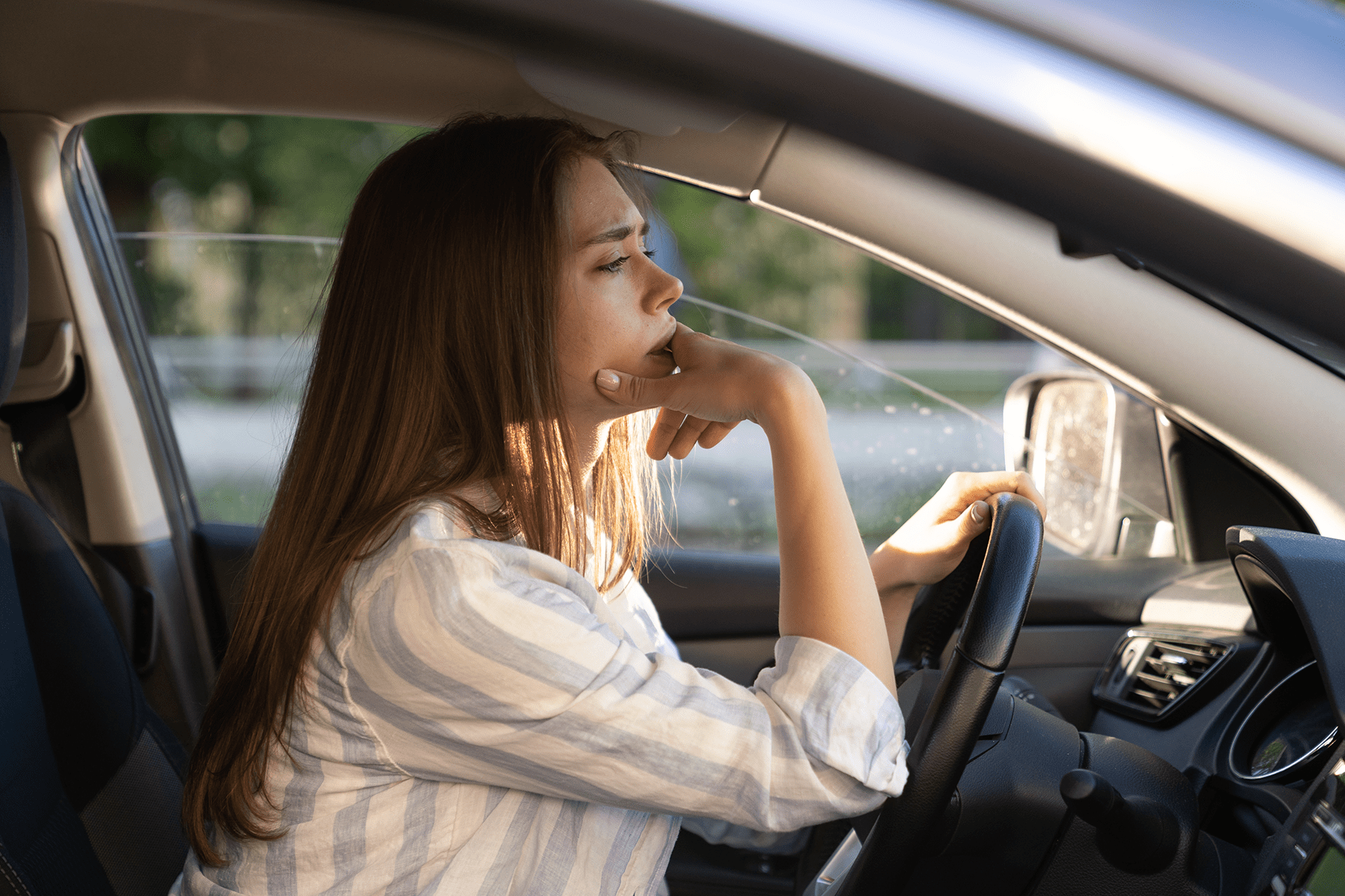 a concerned woman driving a car