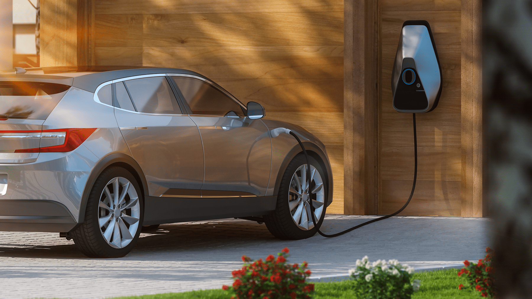 An electric car charging at home in the drive way.