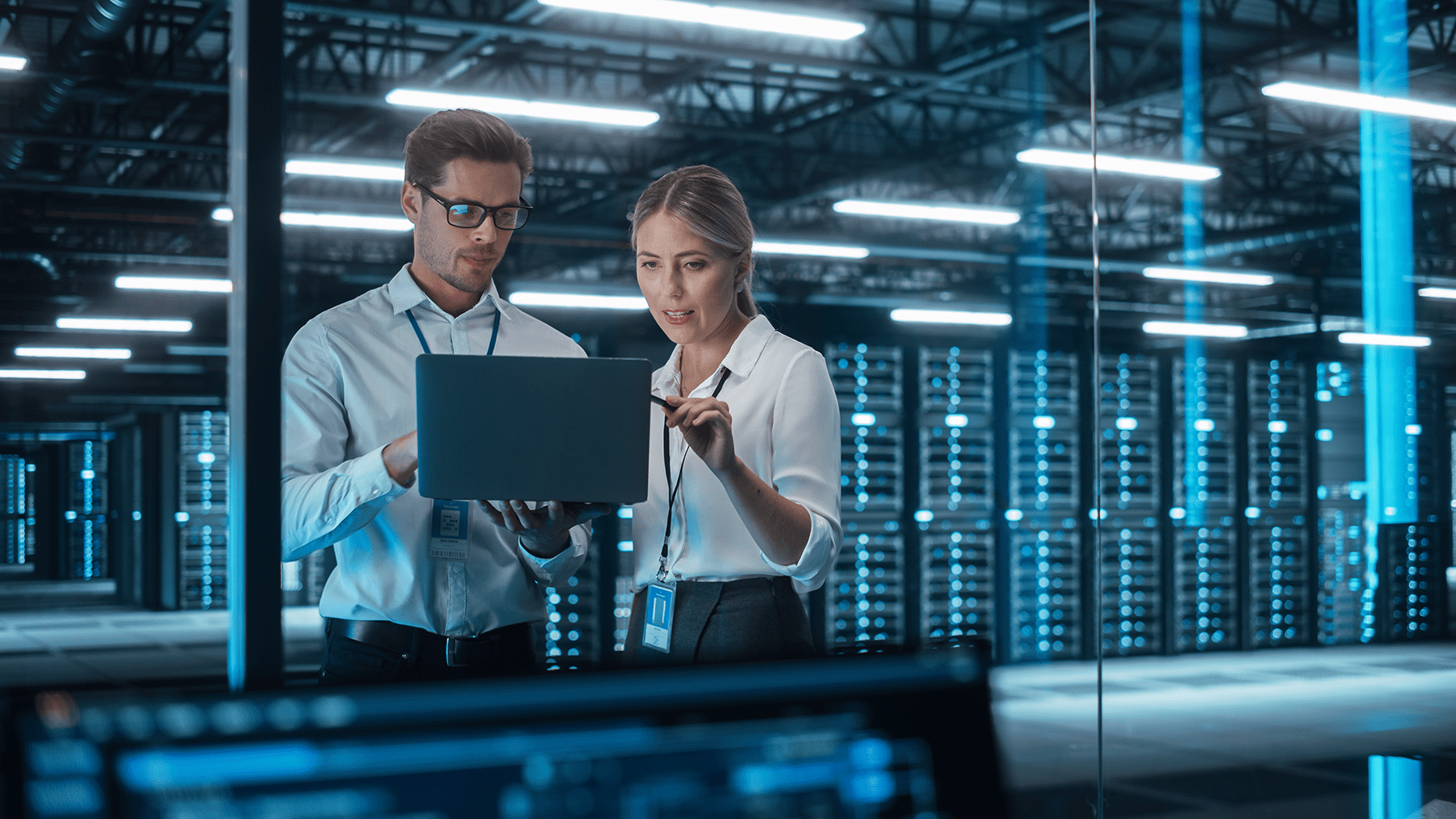 man and woman discussing infront of a laptop