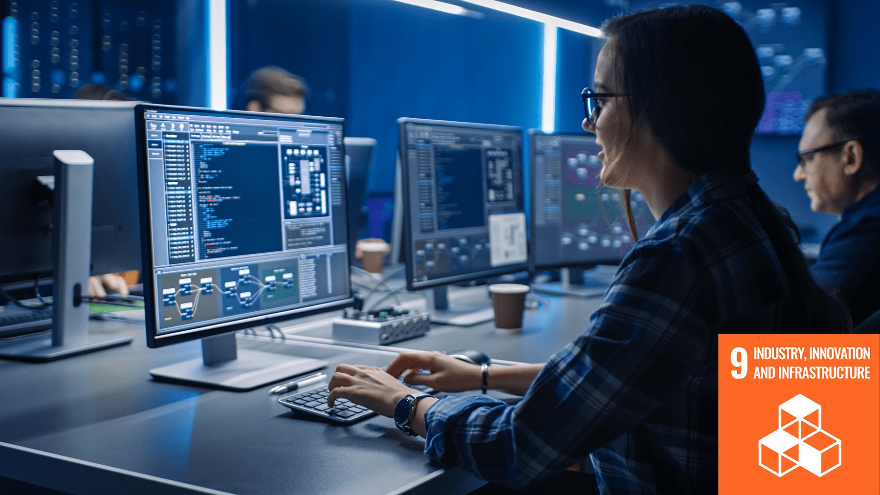 woman in tech working infront of the computer with SDG icon