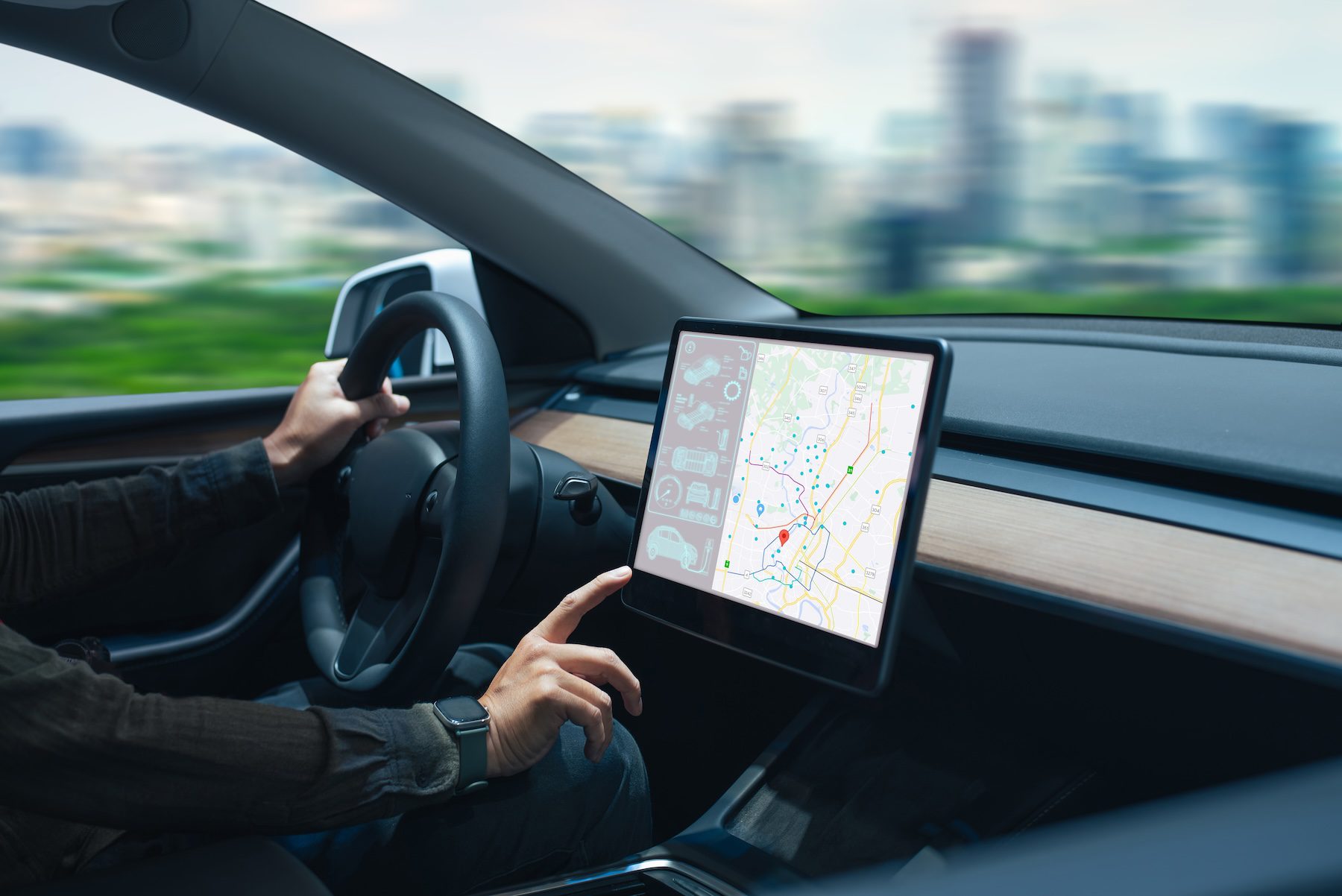 Person driving car while interacting with touchscreen