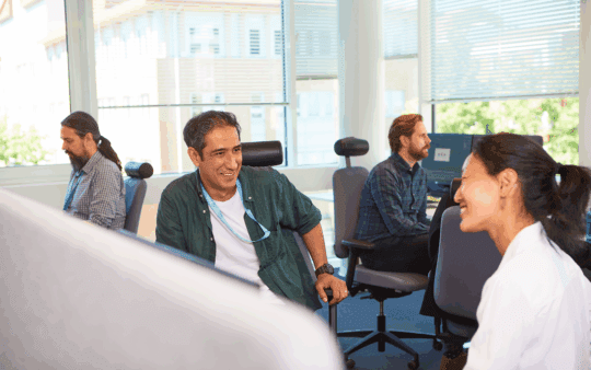 a man and a woman talking and smiling at each other