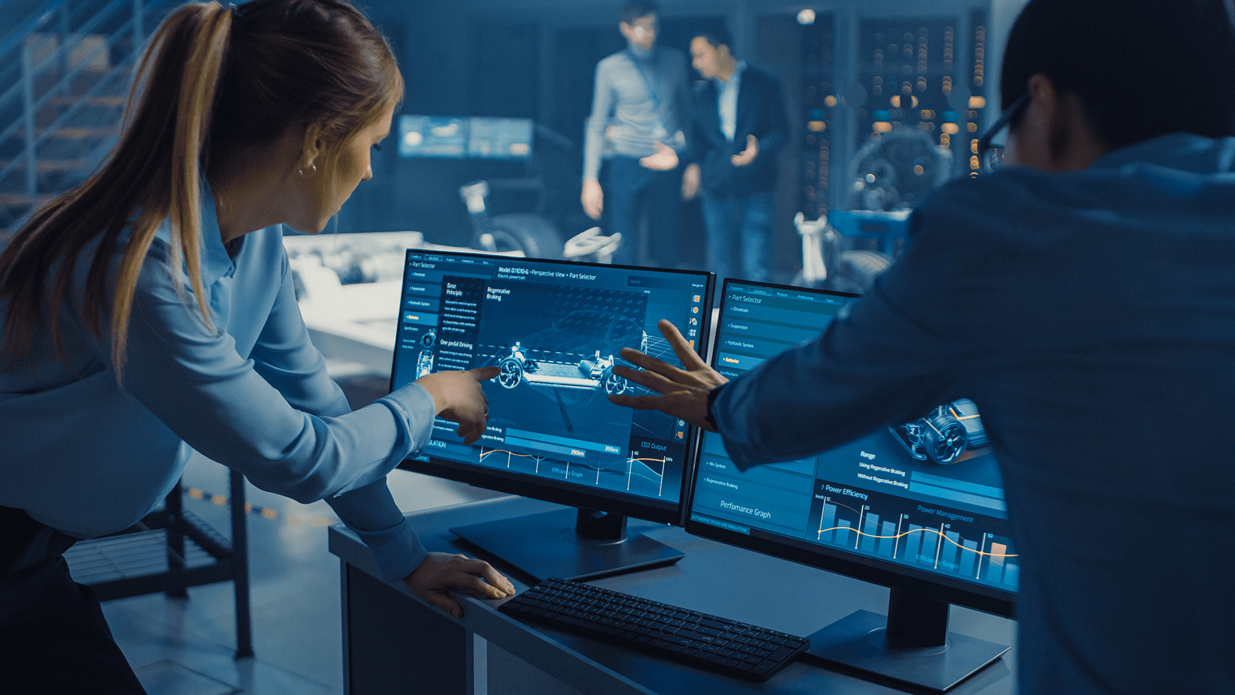 Engineers discussing the 3D render of an electric car